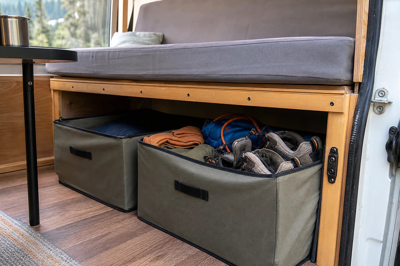 Collapsible storage bins organized inside a camper van rental