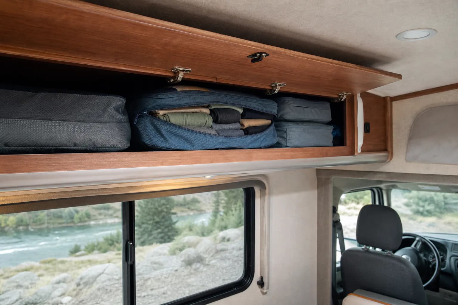 Packing cubes stored in a camper van cabinet