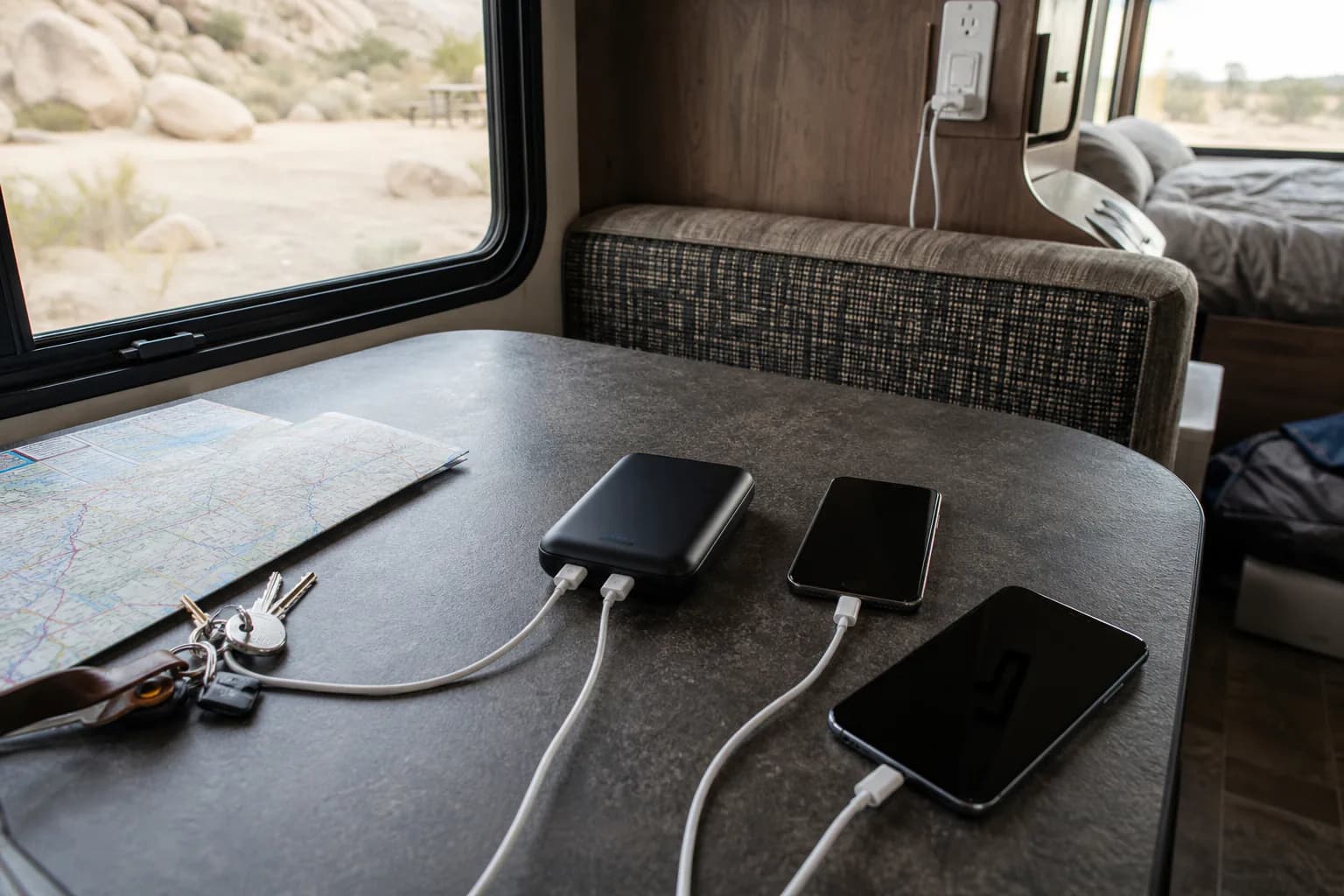Portable power bank charging phones during an RV road trip